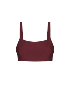 Bordeaux red crop top with thin straps and smooth ribbed texture, front view on white background