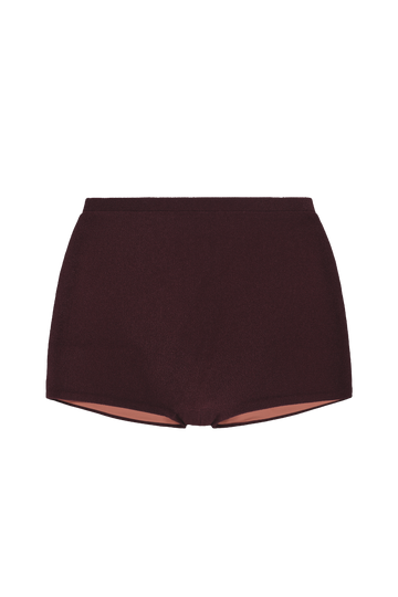 Sienna mini shorts in deep burgundy ribbed knit, front view with elastic waistband and exposed peach lining at hem.